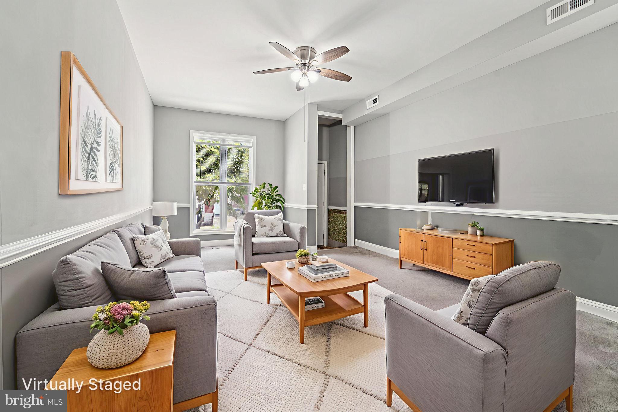 1820 East Lafayette Avenue Baltimore, MD 21213 - Photo 5 of 17 a living room with furniture and a flat screen tv