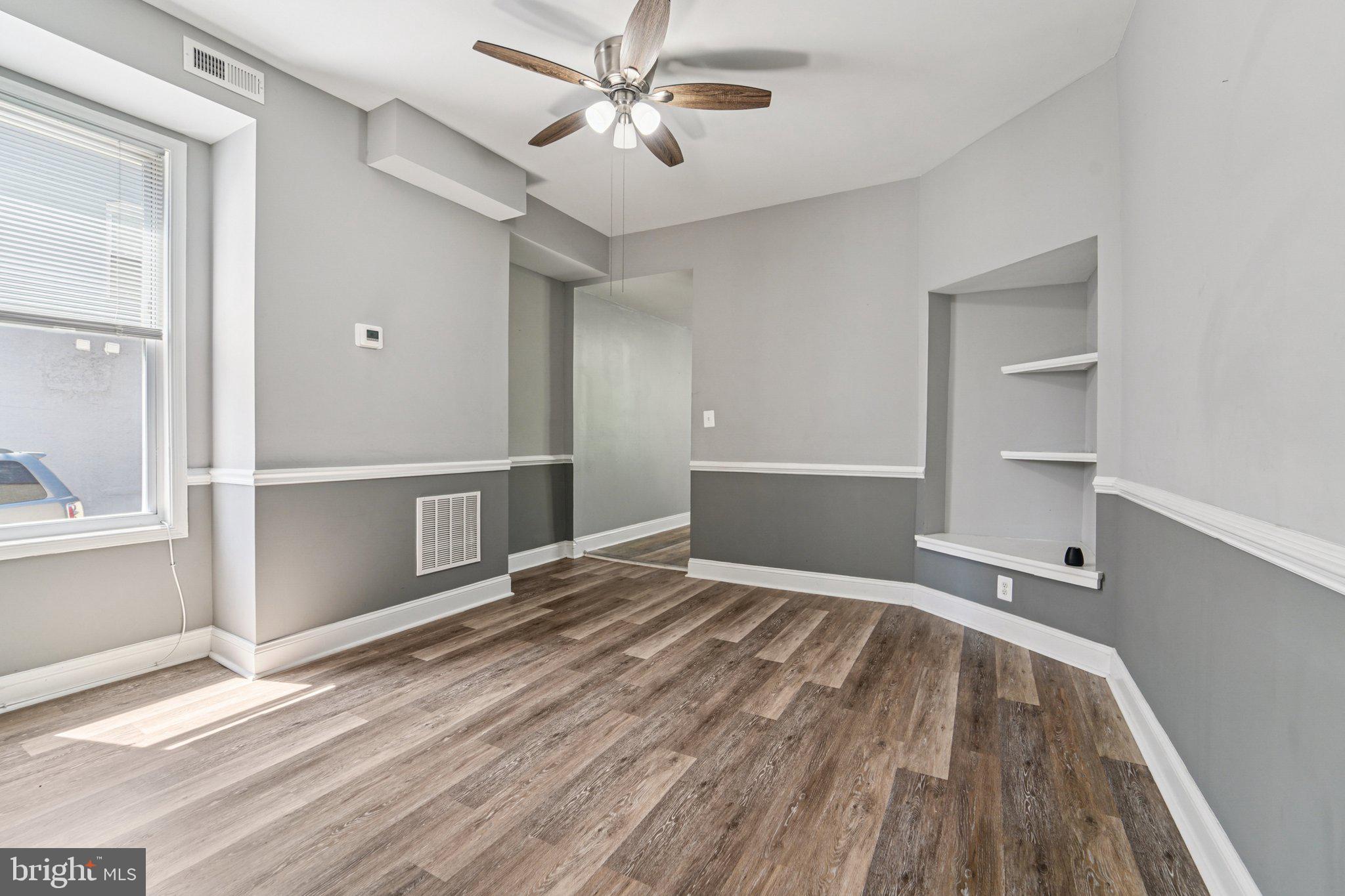 1820 East Lafayette Avenue Baltimore, MD 21213 - Photo 6 of 17 a view of empty room with wooden floor and fan