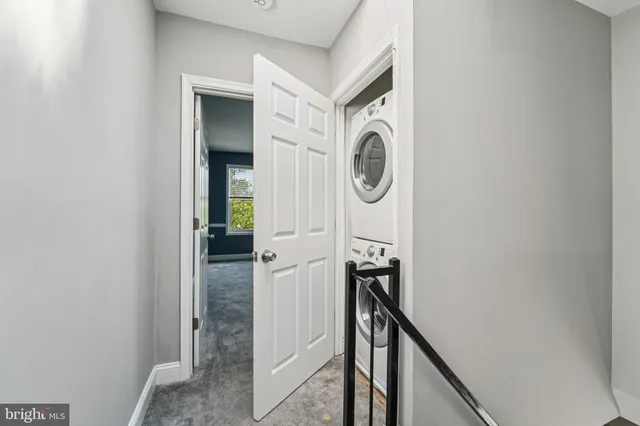 a view of a hallway with washer and dryer