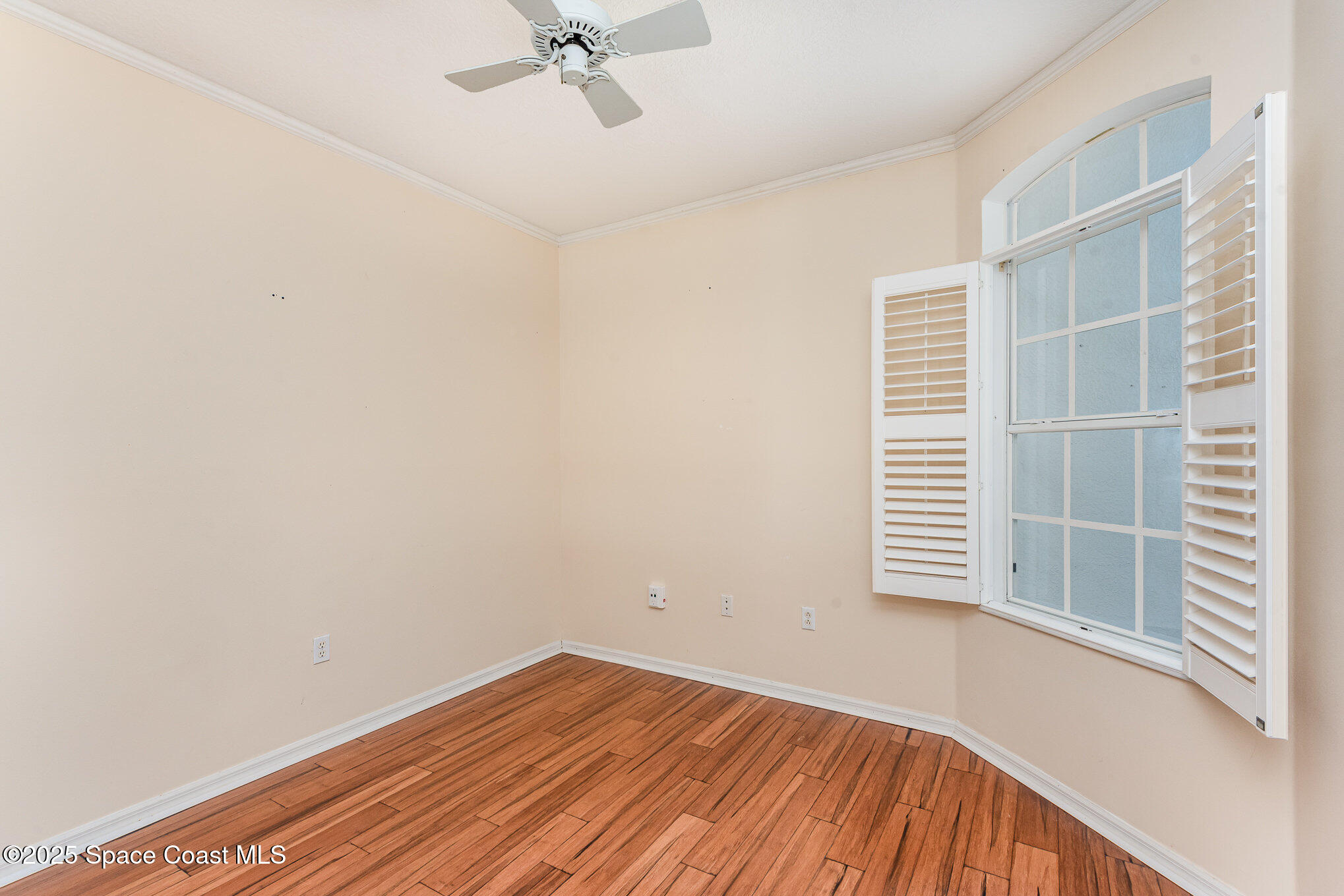 2597 Addington Circle Rockledge, FL 32955 - Photo 12 of 28 a view of a room with wooden floor and windows