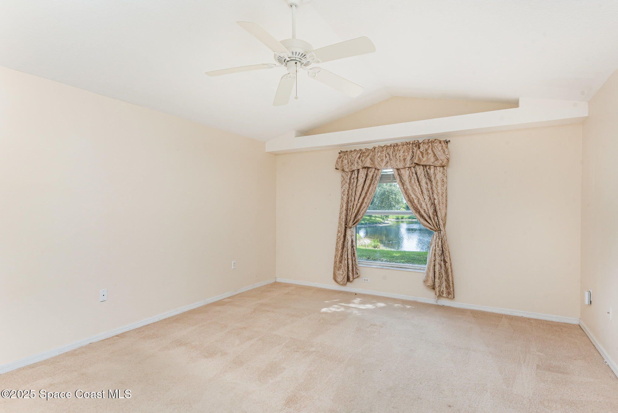 2597 Addington Circle Rockledge, FL 32955 - Photo 14 of 28 an empty room with a ceiling fan and window
