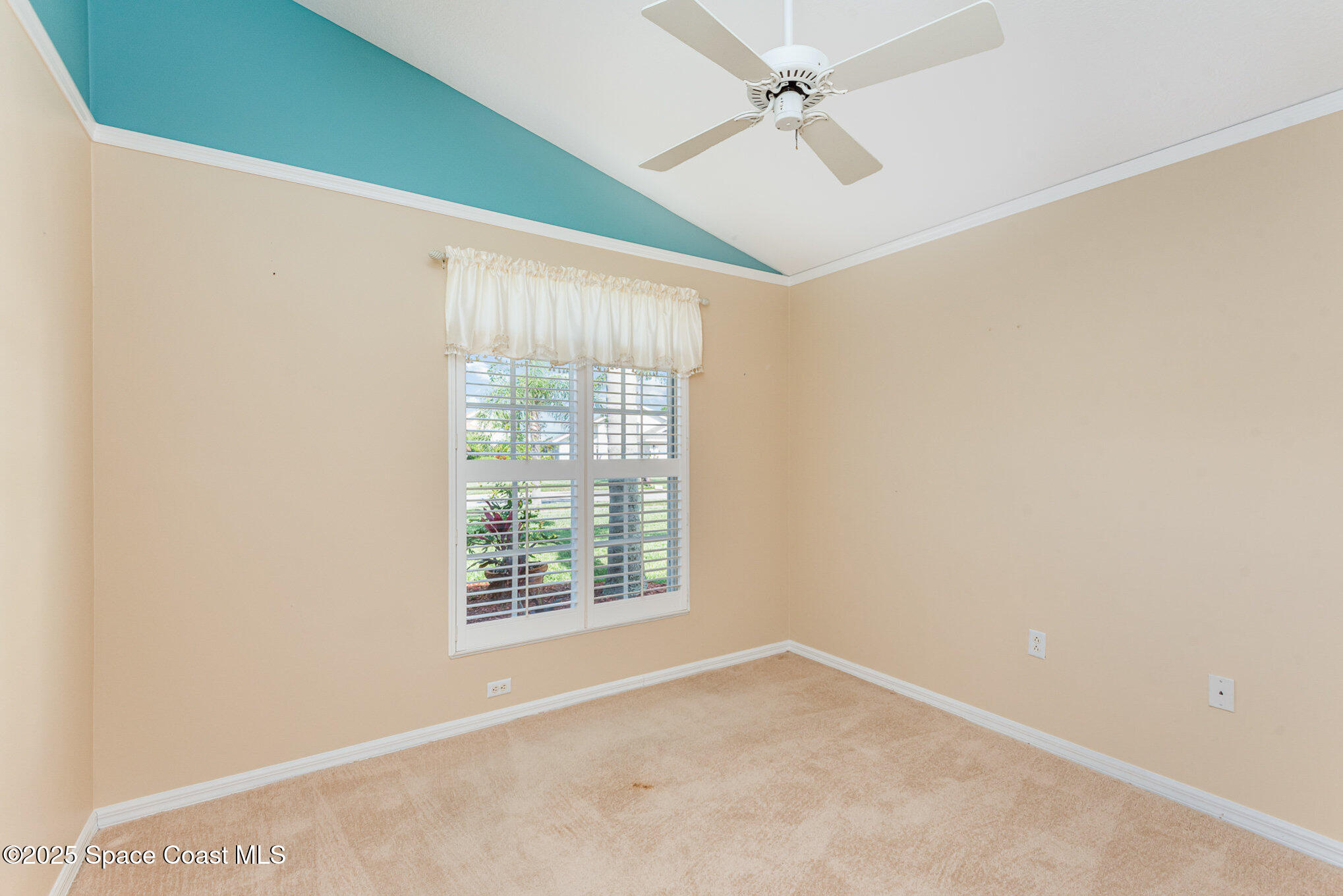 2597 Addington Circle Rockledge, FL 32955 - Photo 18 of 28 an empty room with windows and fan