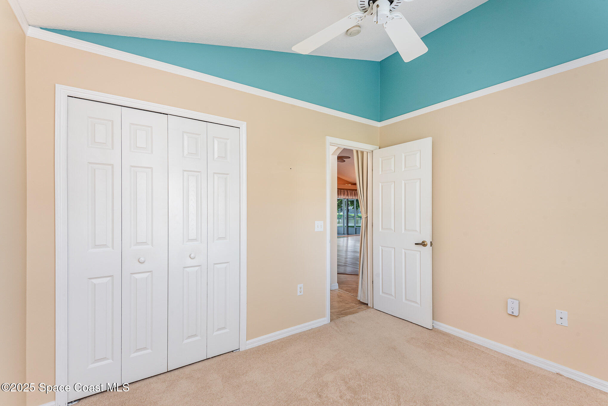 2597 Addington Circle Rockledge, FL 32955 - Photo 19 of 28 a view of a room with a chandelier fan and closet