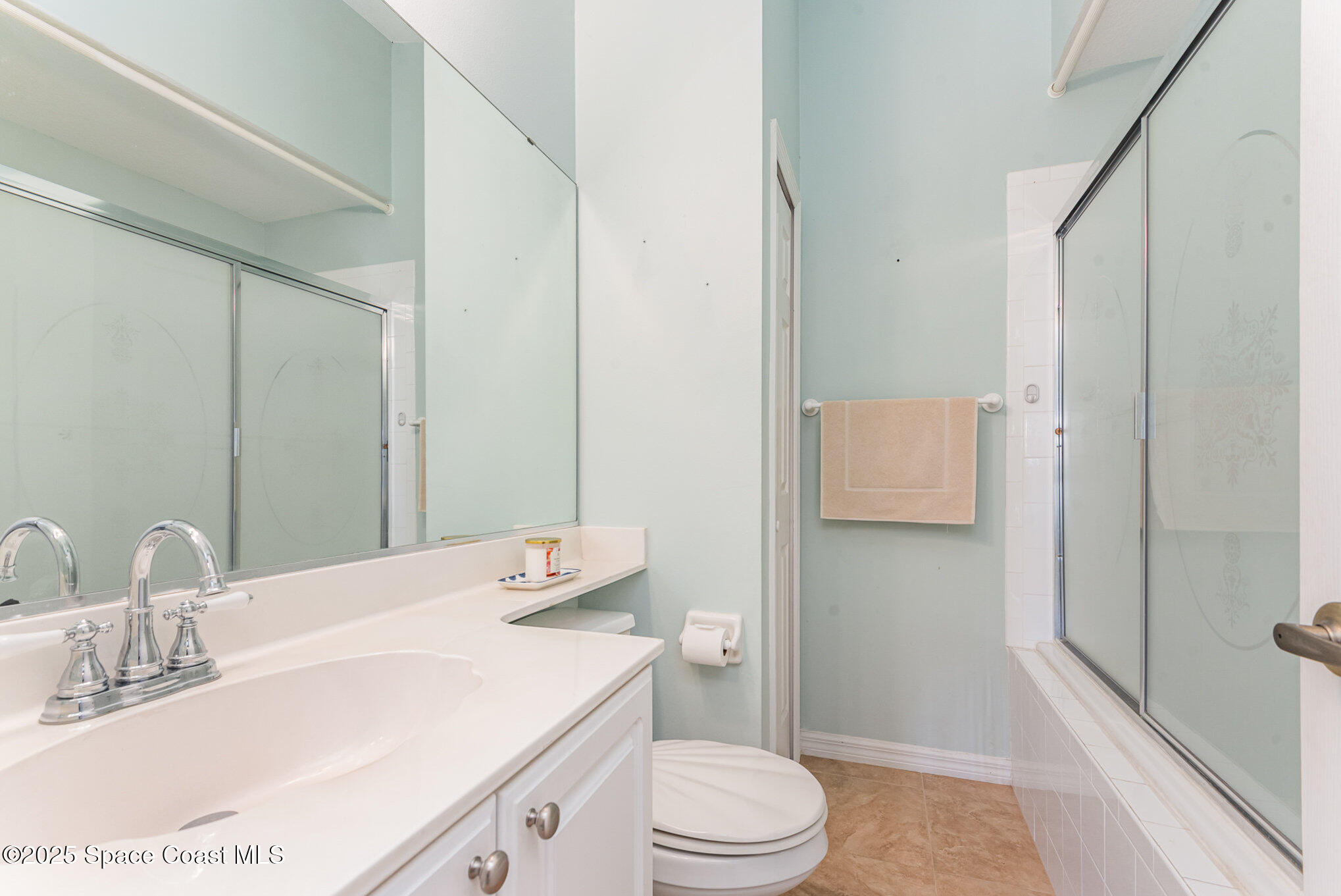 2597 Addington Circle Rockledge, FL 32955 - Photo 20 of 28 a bathroom with a sink a toilet and shower