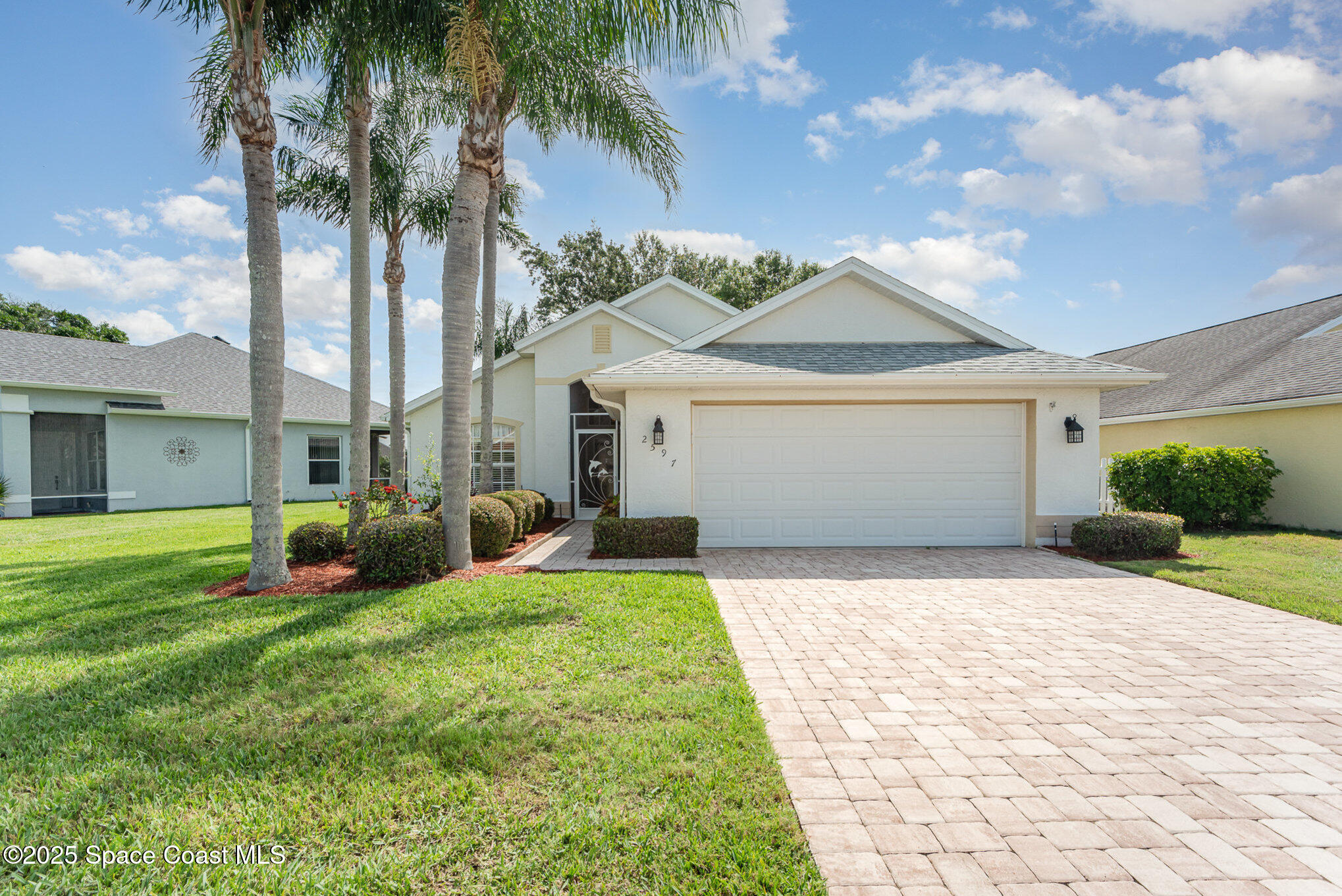 2597 Addington Circle Rockledge, FL 32955 - Photo 2 of 28 a front view of a house with garden
