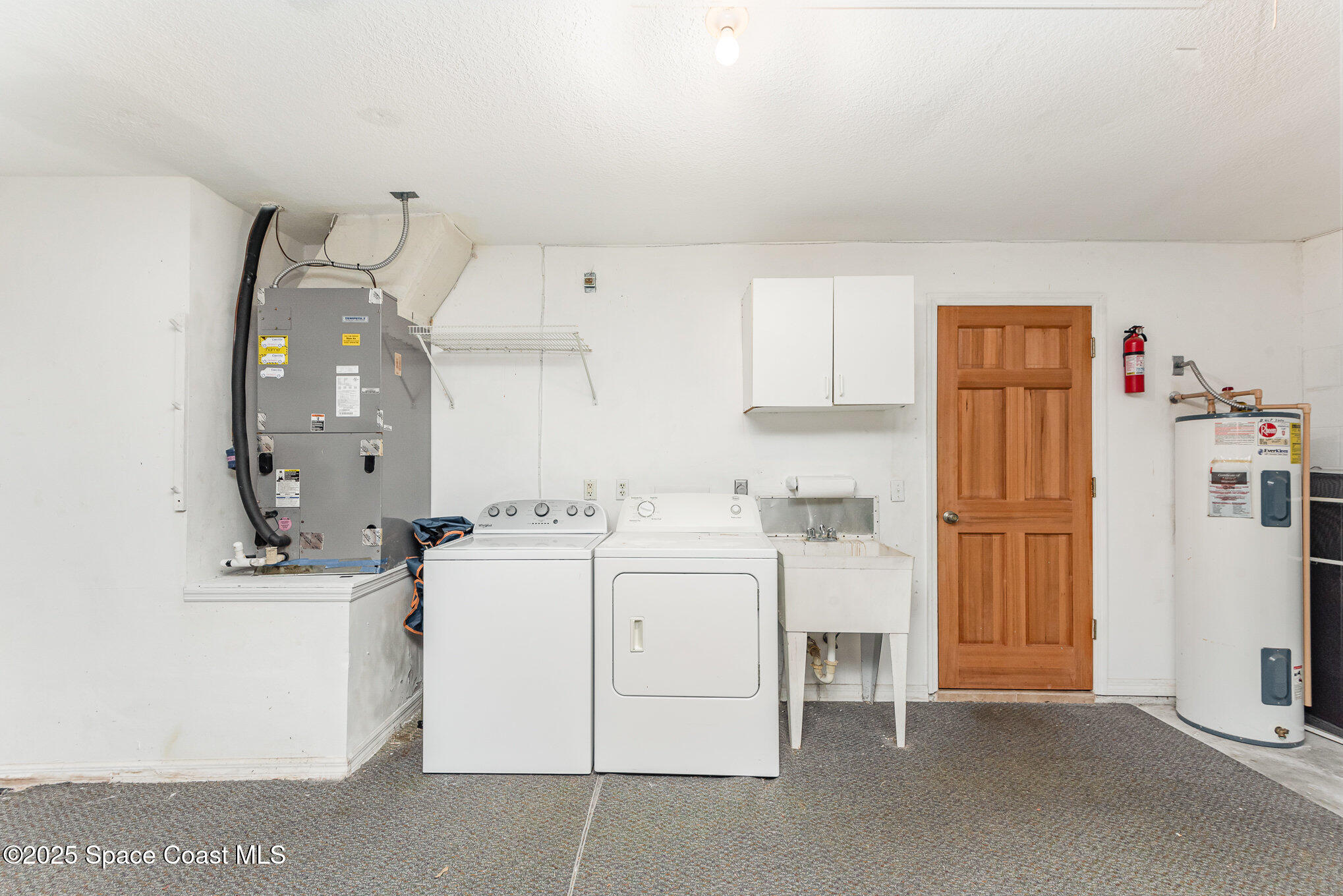 2597 Addington Circle Rockledge, FL 32955 - Photo 21 of 28 a kitchen with a sink a stove and refrigerator