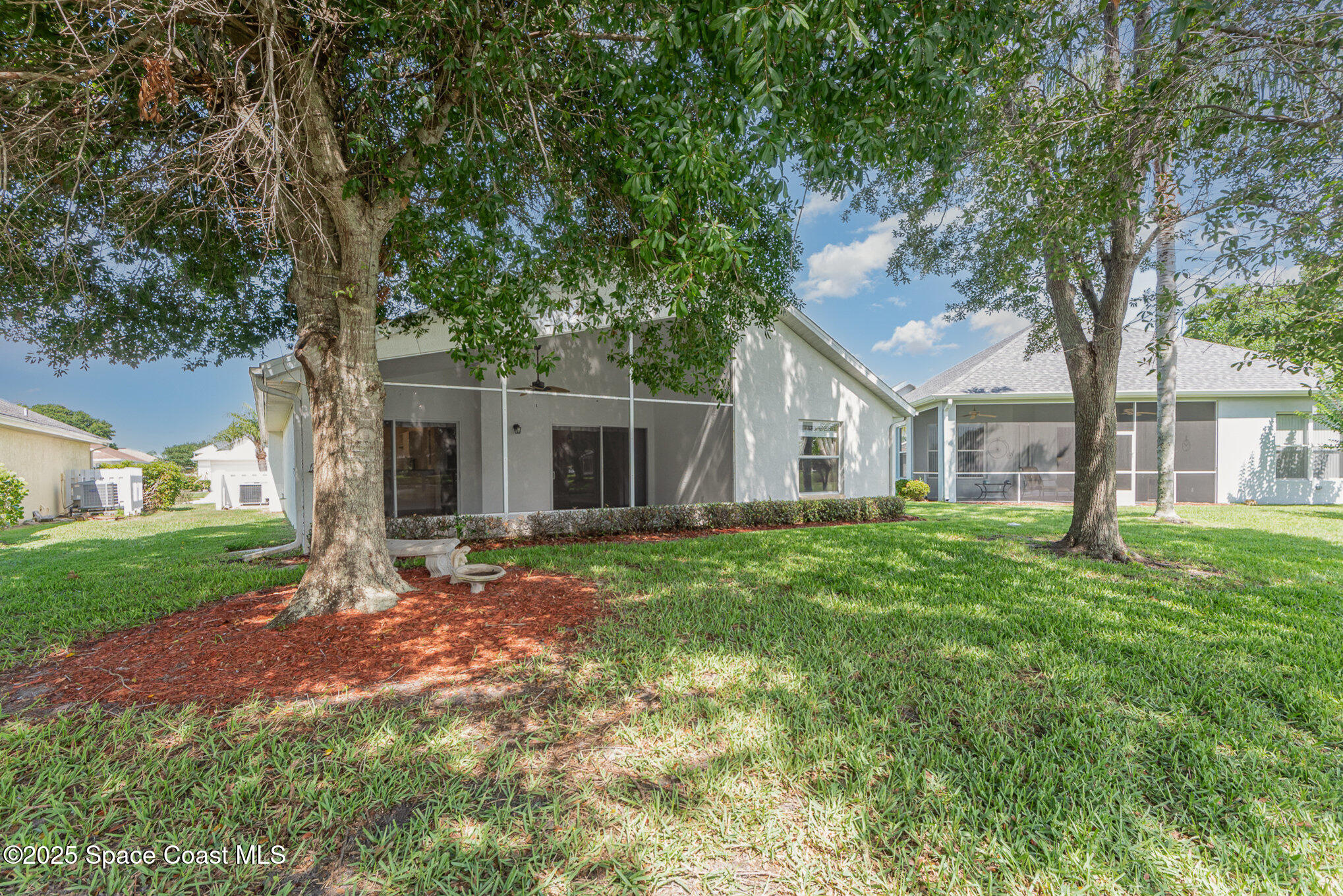 2597 Addington Circle Rockledge, FL 32955 - Photo 23 of 28 a view of a house with yard and a tree