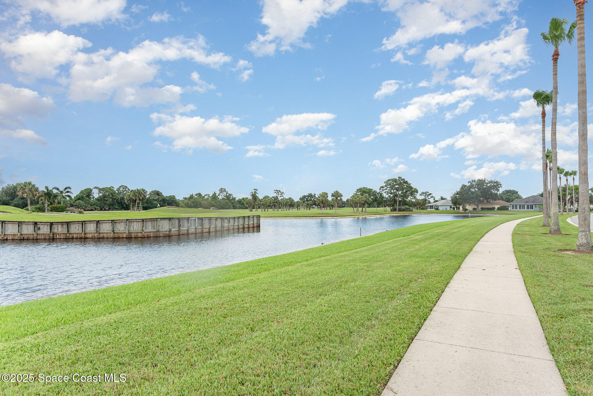 2597 Addington Circle Rockledge, FL 32955 - Photo 26 of 28 a view of a lake with a yard