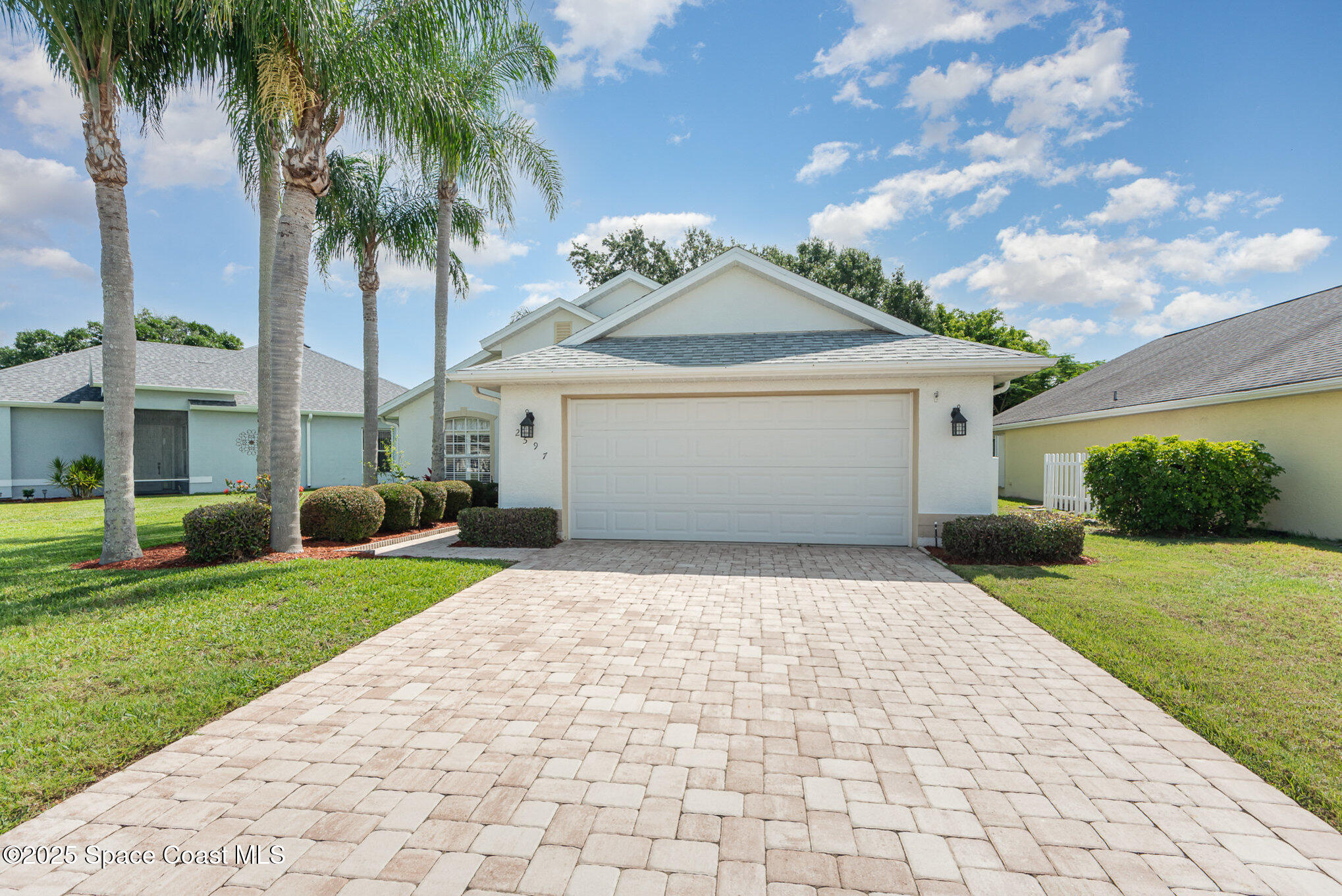 2597 Addington Circle Rockledge, FL 32955 - Photo 3 of 28 a front view of a house with a garden