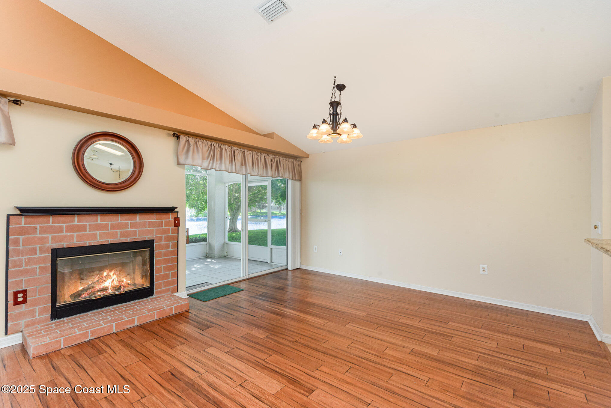 2597 Addington Circle Rockledge, FL 32955 - Photo 7 of 28 a view of a livingroom with a fireplace and a fan