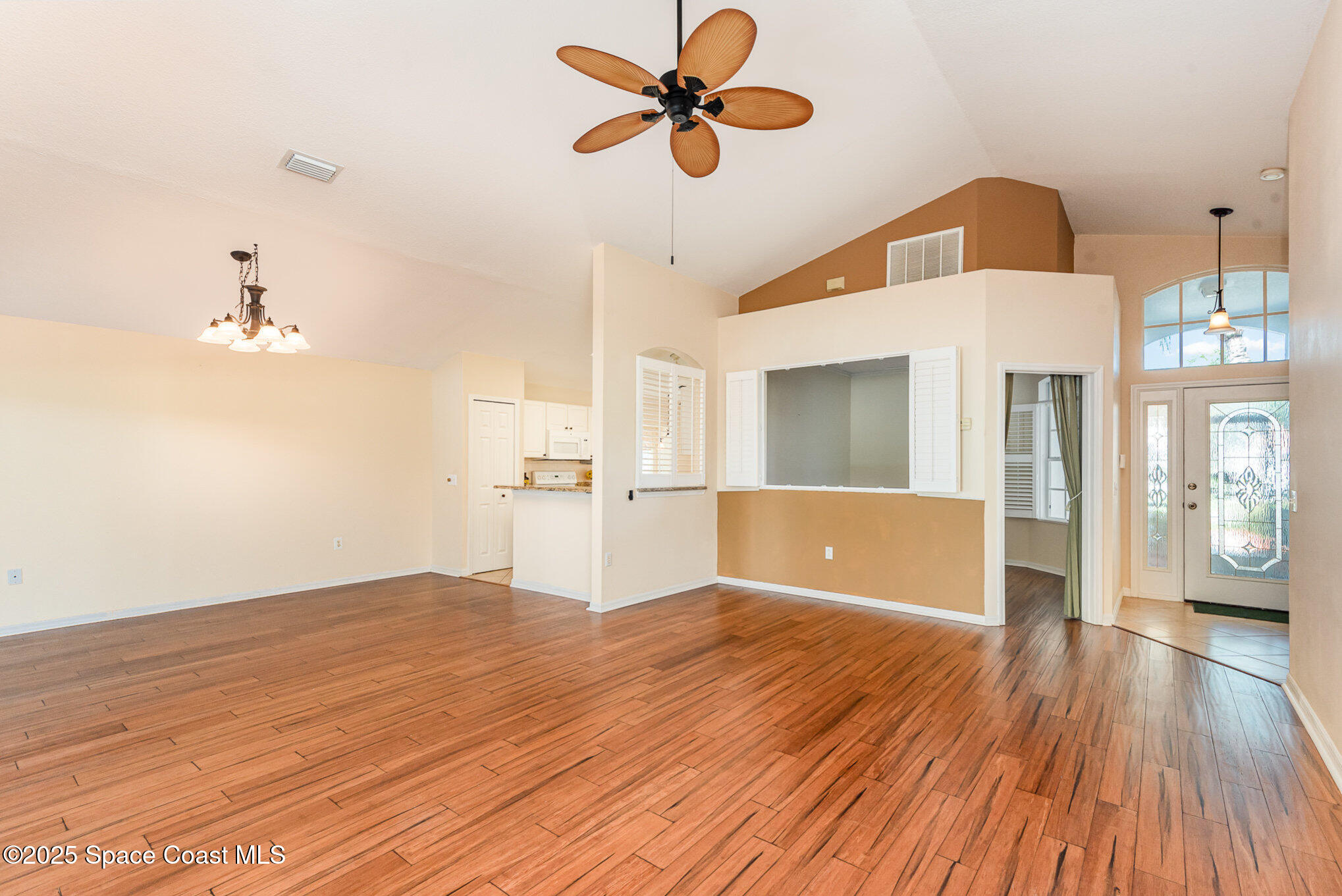 2597 Addington Circle Rockledge, FL 32955 - Photo 9 of 28 a view of a kitchen with wooden floor and a ceiling fan