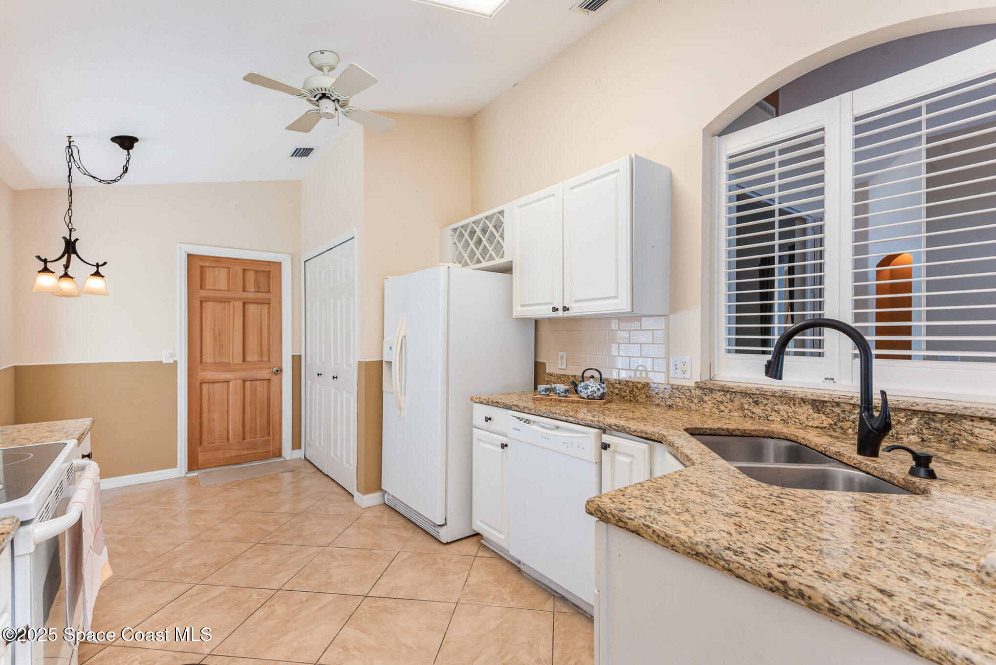 2597 Addington Circle Rockledge, FL 32955 - Photo 10 of 28 a kitchen with stainless steel appliances granite countertop a sink stove and refrigerator