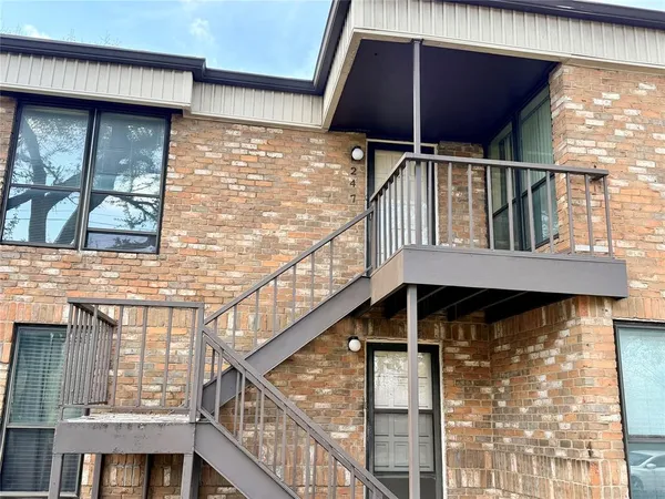 a view of balcony with small yard