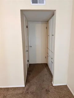 a view of hallway with closet