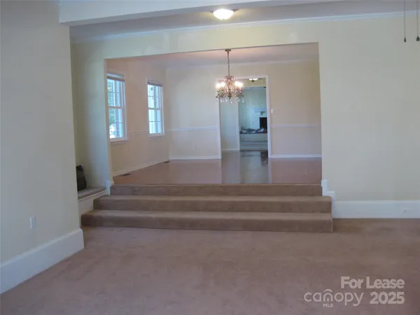 a view of staircase with kitchen island wooden floor and view living room