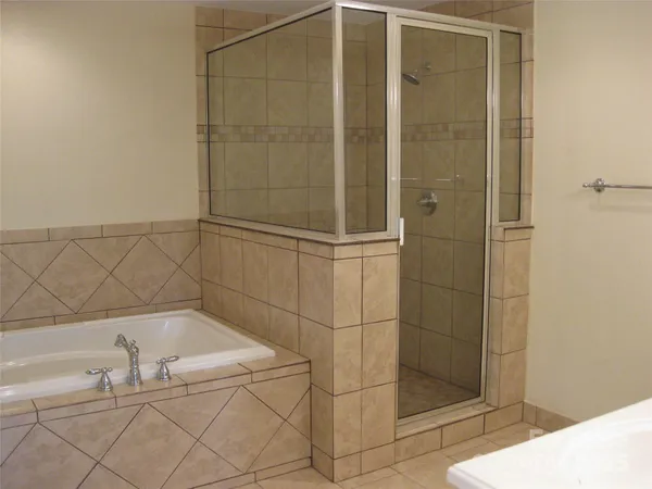 a bathroom with a bath tub and shower