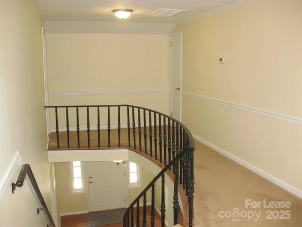 an empty room with a ceiling fan and a window