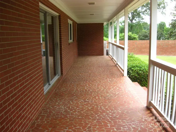 a view of a porch with wooden floor and fence