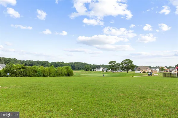 a view of a green field with clear sky