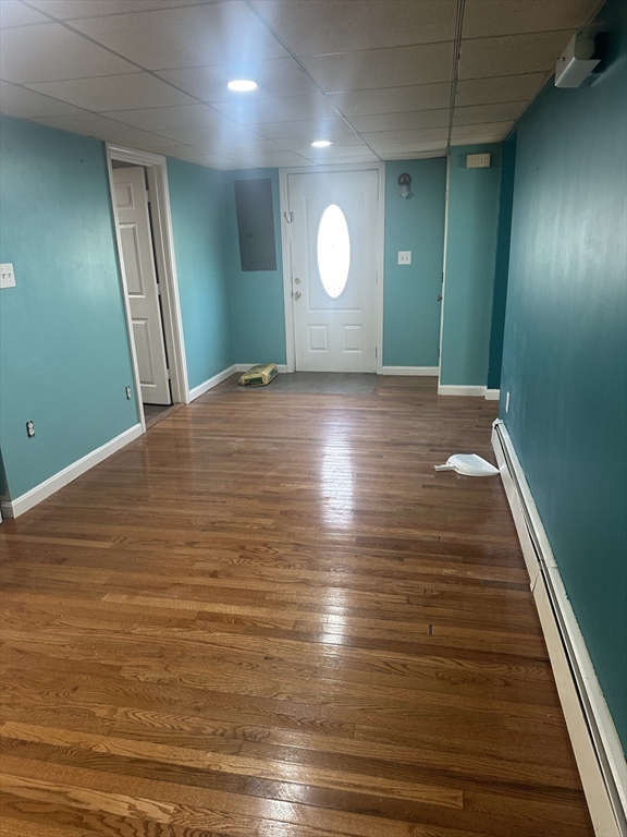 56 Howe Avenue, Unit 1 Shrewsbury, MA 01545 - Photo 2 of 10 an empty room with wooden floor and windows