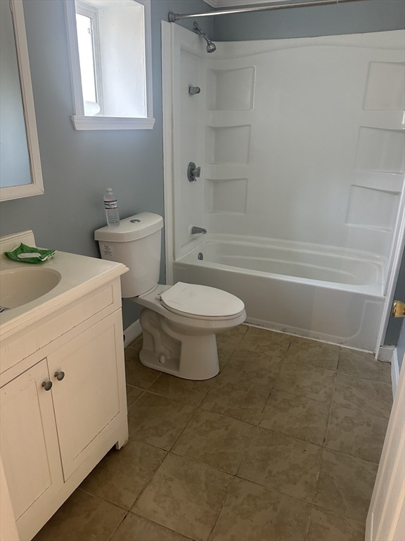 56 Howe Avenue, Unit 1 Shrewsbury, MA 01545 - Photo 4 of 10 a bathroom with a sink a toilet and shower
