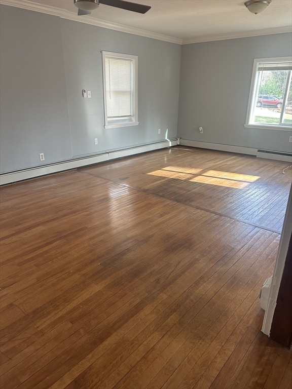 56 Howe Avenue, Unit 1 Shrewsbury, MA 01545 - Photo 5 of 10 an empty room with wooden floor and windows