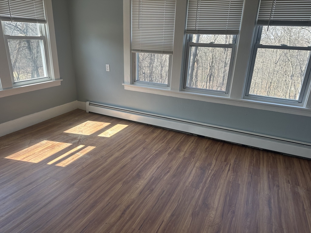 56 Howe Avenue, Unit 1 Shrewsbury, MA 01545 - Photo 7 of 10 a view of empty room with wooden floor and fan