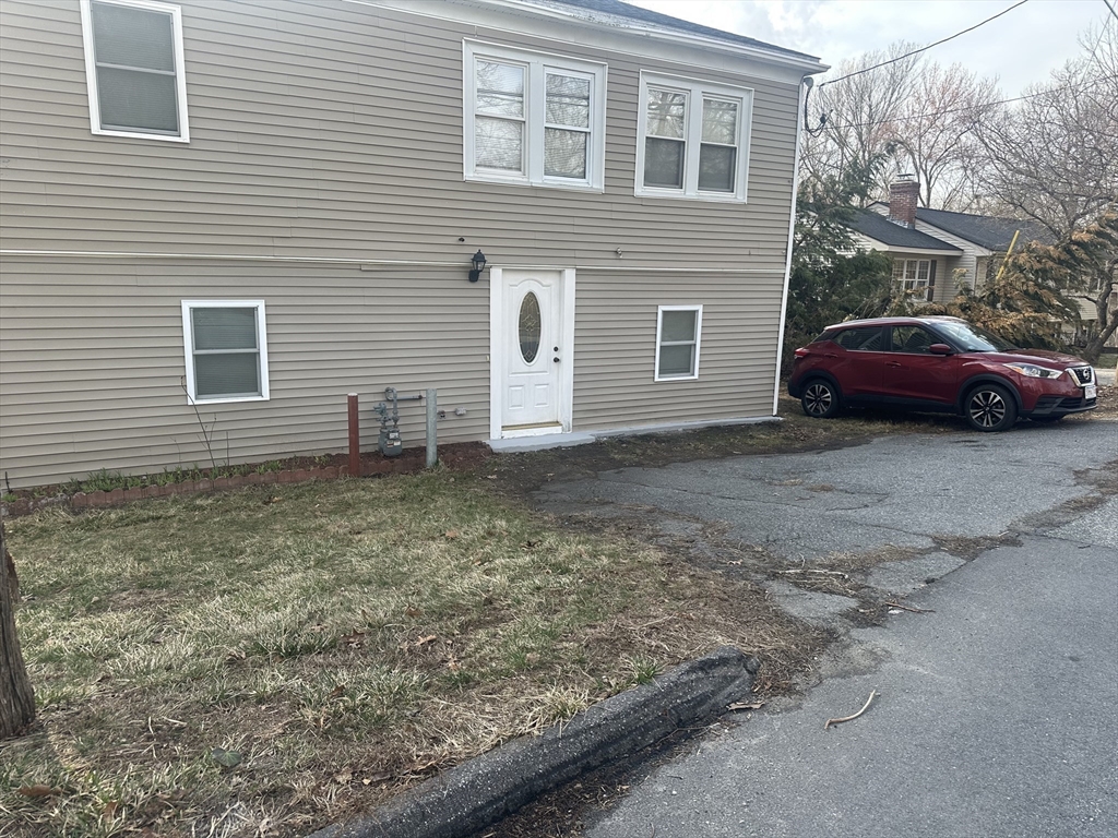 56 Howe Avenue, Unit 1 Shrewsbury, MA 01545 - Photo 10 of 10 a view of a house with a backyard space