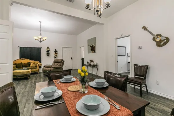a living room with furniture and a chandelier