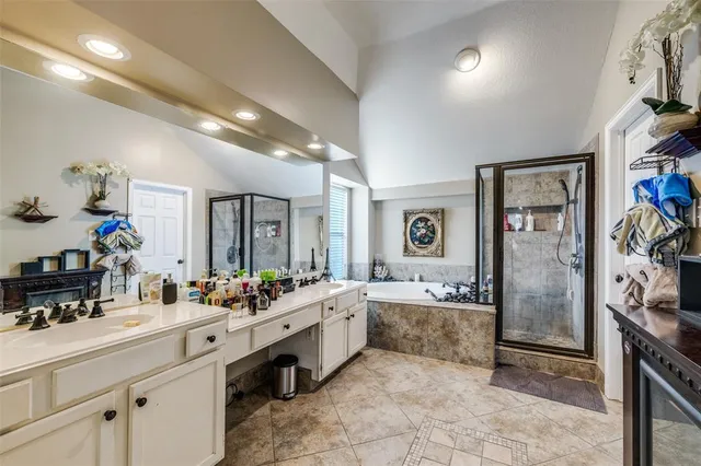 a spacious bathroom with a double vanity sink a mirror and a shower