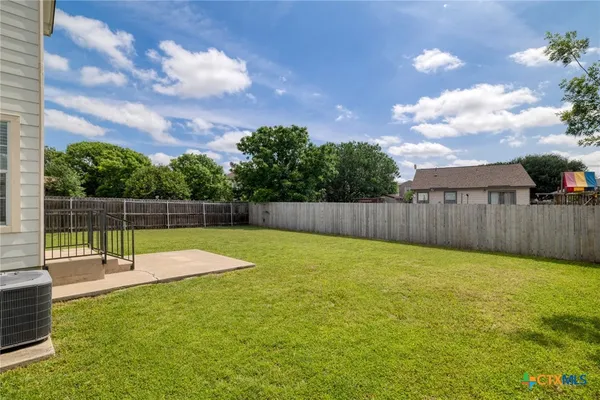 a view of a backyard with grass and a palm tree
