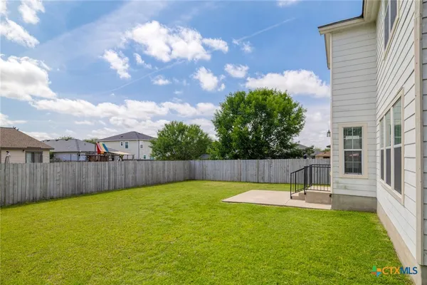 a swimming pool with outdoor seating and yard