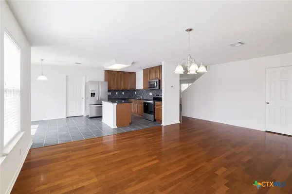 a view of a kitchen with a sink a refrigerator and a fireplace