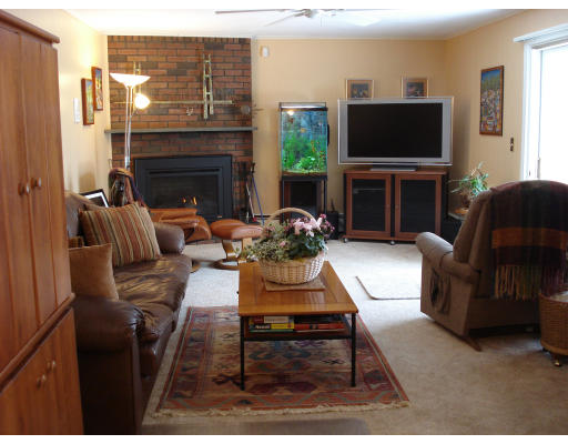 7 Eisenhower Road Marblehead, MA 01945 - Photo 3 of 9 a living room with furniture a fireplace and a flat screen tv