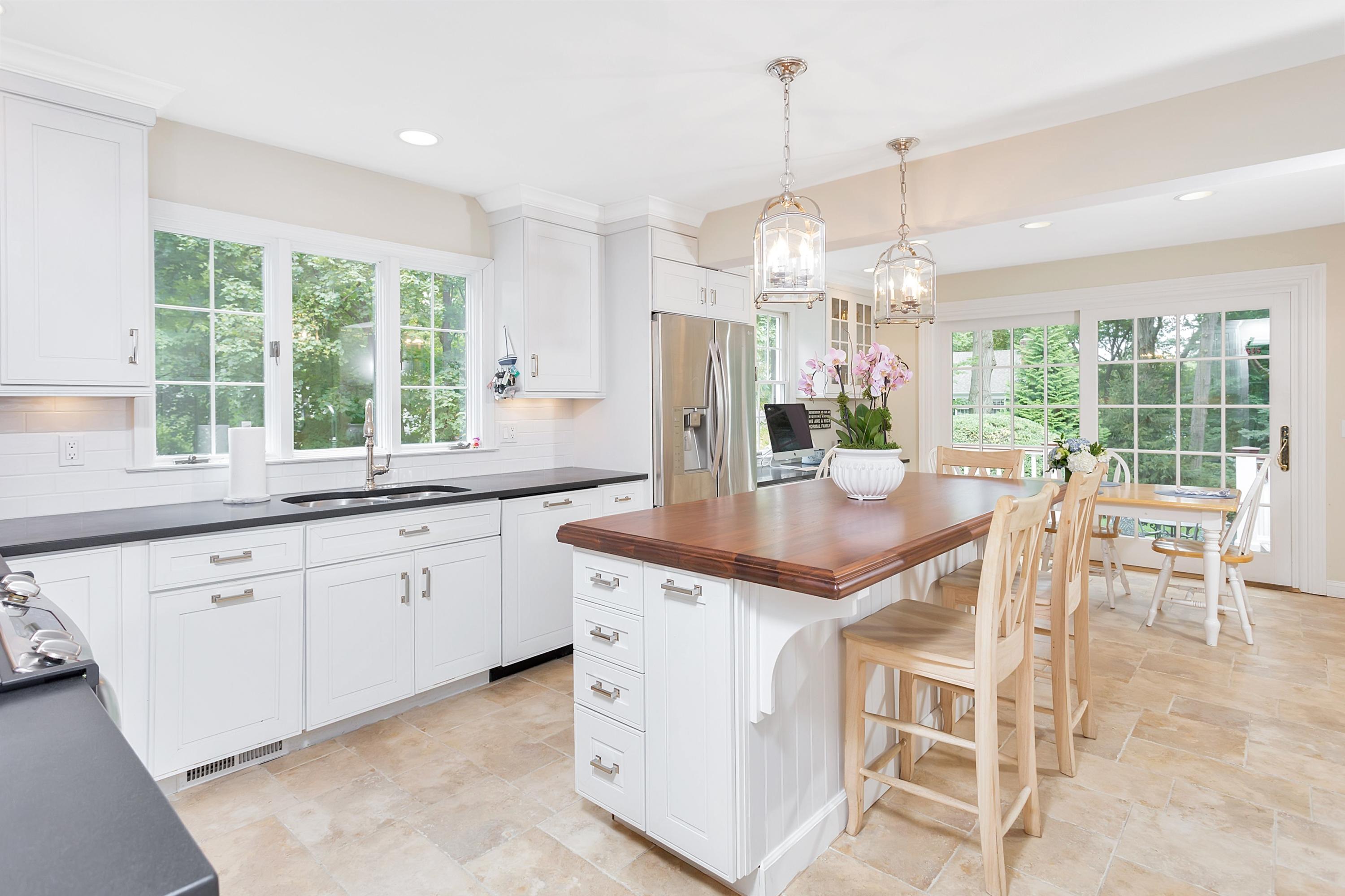73 Locust Hill Road Darien, CT 06820 - Photo 8 of 34 a kitchen with granite countertop stainless steel appliances a table and chairs in it