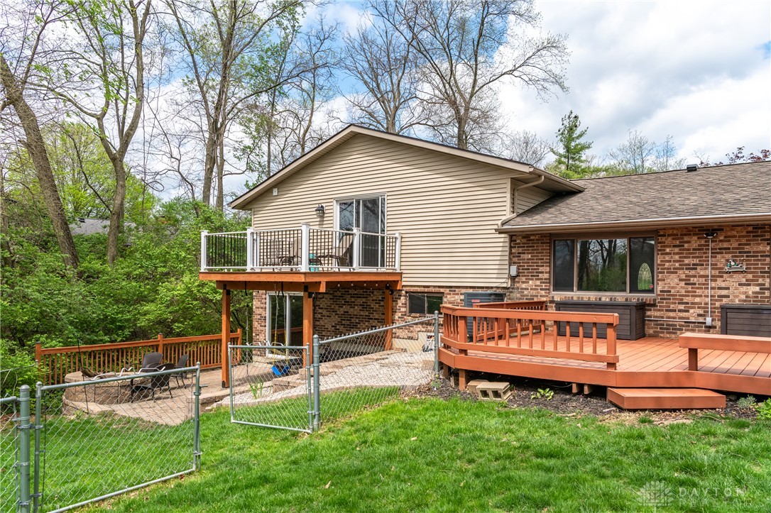 728 Chipplegate Drive Centerville, OH 45459 - Photo 24 of 30 Enjoy outdoor living with expansive decking, perfect for gatherings amidst lush surroundings.