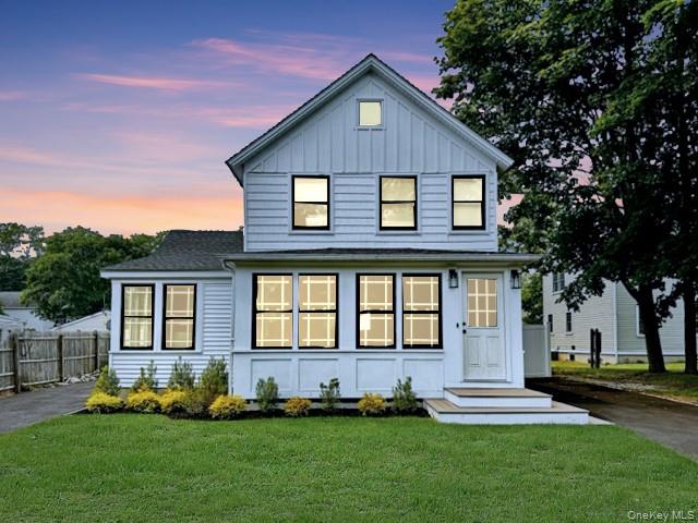 275 Sound Road Greenport, NY 11944 - Photo 11 of 28 View of front of house featuring board and batten siding, driveway, and a shingled roof