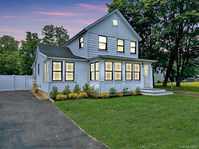 275 Sound Road Greenport, NY 11944 - Photo 13 of 28 View of front of home with asphalt driveway, board and batten siding, a front yard, and a gate
