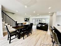 275 Sound Road Greenport, NY 11944 - Photo 14 of 28 Dining area with light wood-style flooring, stairs, and recessed lighting