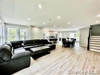 275 Sound Road Greenport, NY 11944 - Photo 19 of 28 Living room featuring stairs, light wood-style floors, and recessed lighting