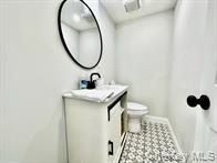 275 Sound Road Greenport, NY 11944 - Photo 21 of 28 Half bath with vanity and toilet