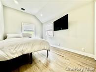 275 Sound Road Greenport, NY 11944 - Photo 23 of 28 Bedroom featuring lofted ceiling and wood finished floors