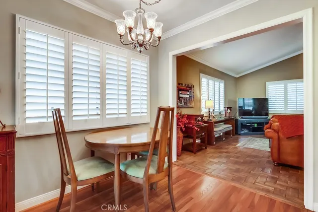 a view of a dining room with furniture and a chandelier