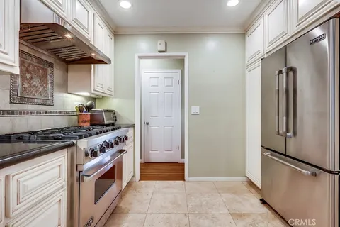 a kitchen with stainless steel appliances granite countertop a stove and a refrigerator