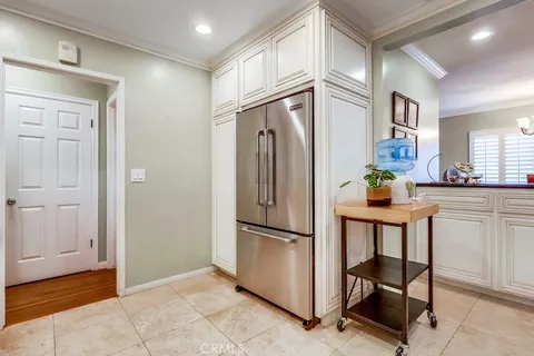a kitchen with stainless steel appliances granite countertop a refrigerator and a refrigerator