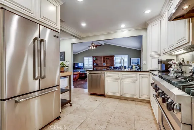 a kitchen with cabinets and stainless steel appliances