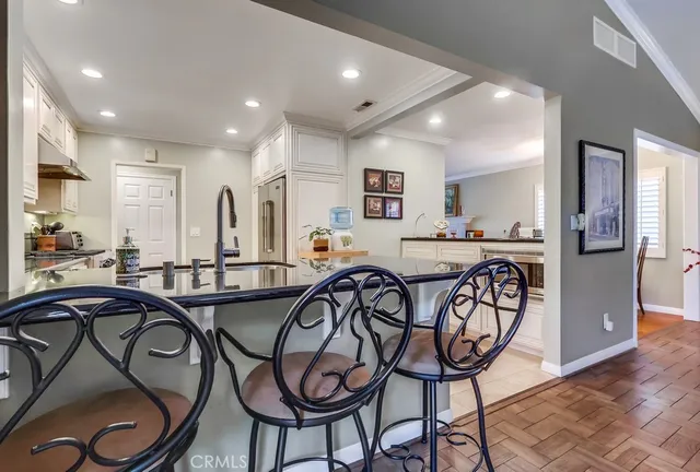 a very nice looking kitchen and a dining table with chairs