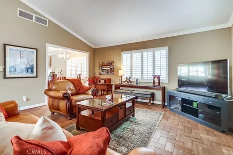 a living room with furniture a rug and a window
