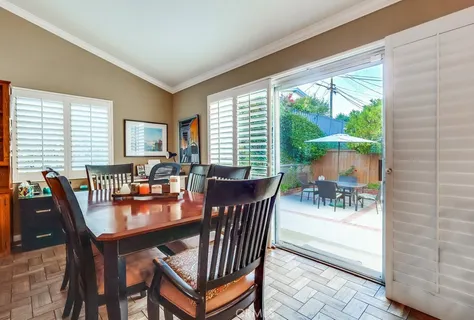 a dining room with furniture window and outside view