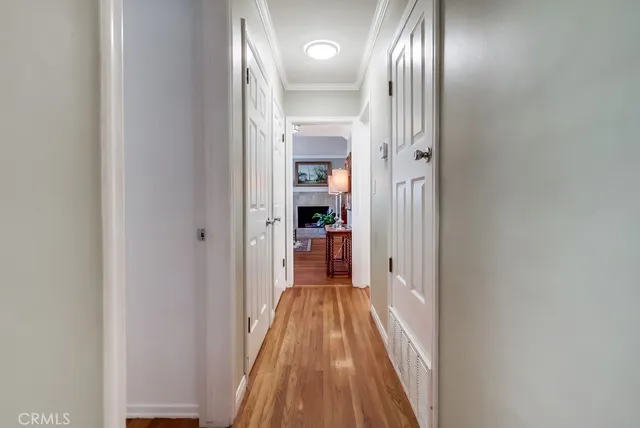 a view of a hallway with wooden floor